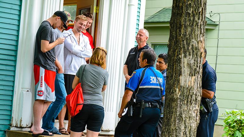 Mayor and police officers' neighborhood walk at student doorstep